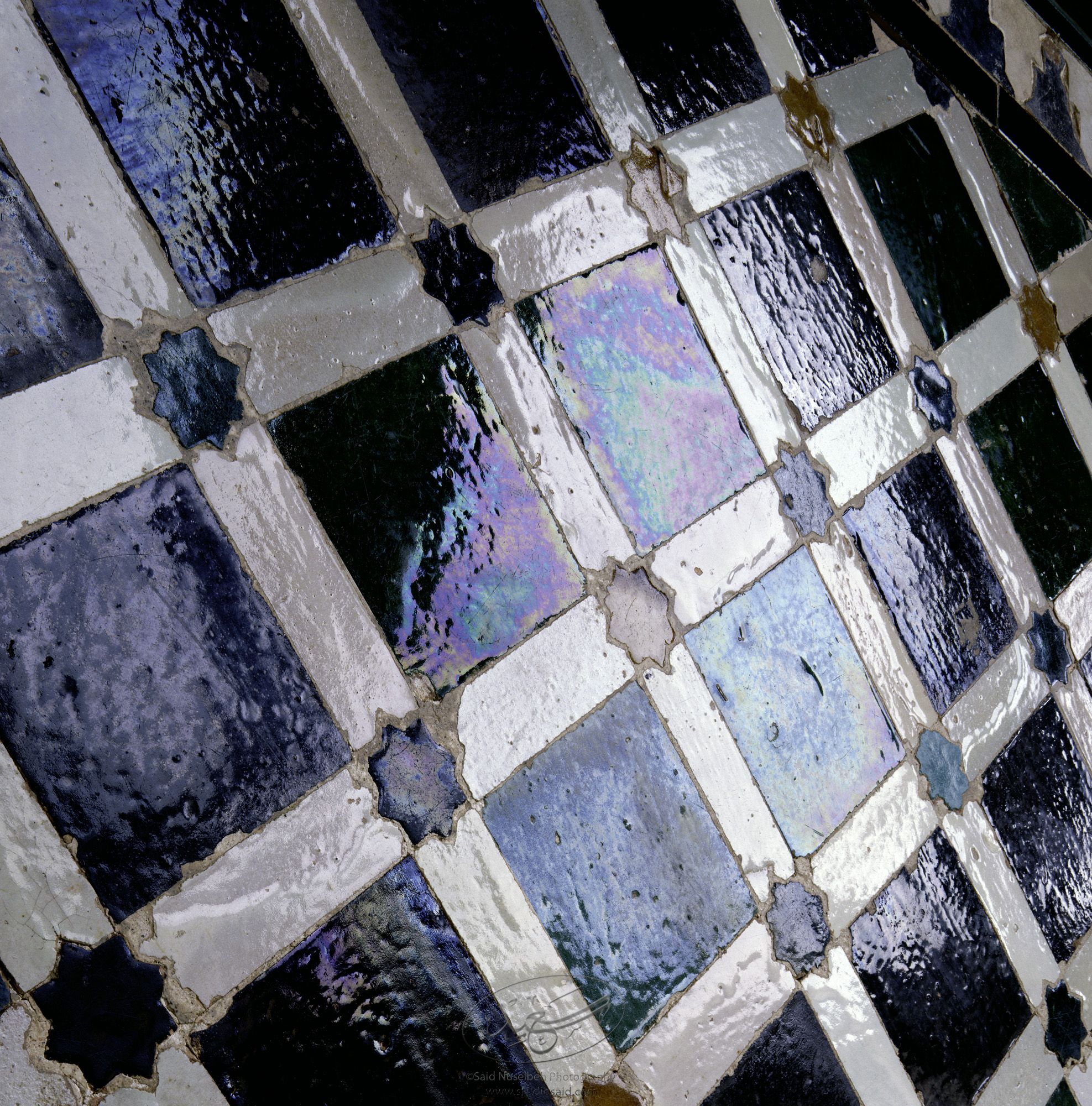 Sala de Cuarto del Dorado, Alhambra, Granada, Espa&ntilde;a. Image of iridescence off the glazed tiles of dados inside the Alhambra, a palace of the Nasrid dynasty in 12<sup>th</sup>&ndash;century Andaluc&igrave;a, Granada, Spain.